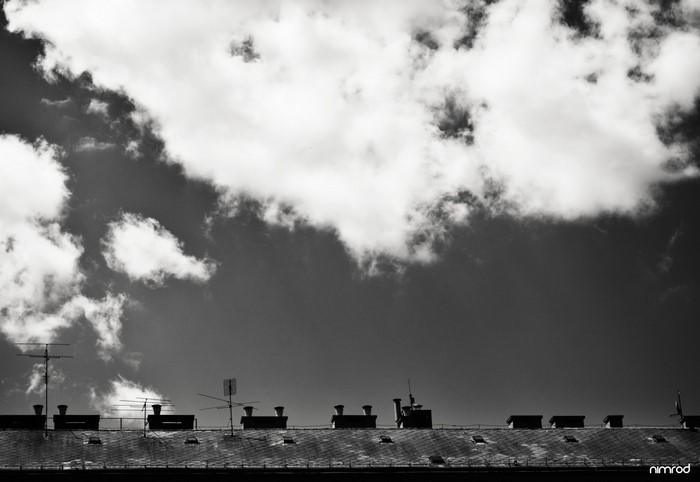 Rooftops and clouds in monochrome photography