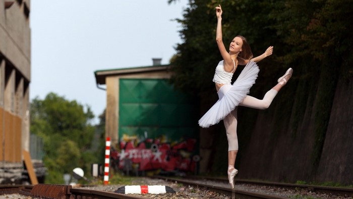 Graceful Ballerina Dancing on Railway Tracks