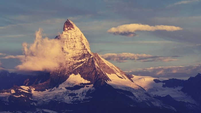 The Matterhorn mountain at sunrise with clouds