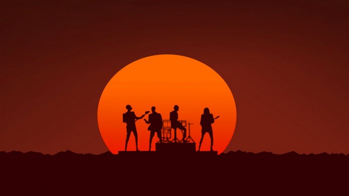 Band performing in front of a large sunset silhouette