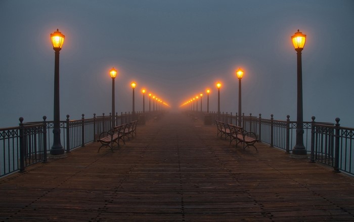 Pier with streetlights in the mist