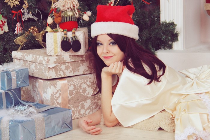 Woman in Santa hat with Christmas gifts