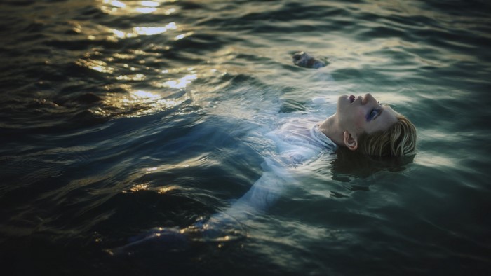 Woman floating in the ocean