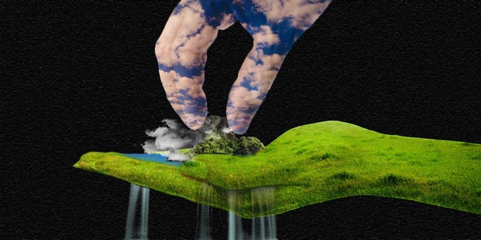 Hand holding a miniature landscape with waterfalls