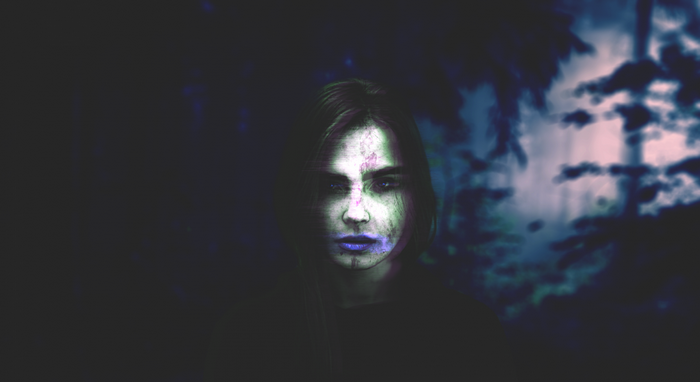Woman with glitch art effect in dark forest
