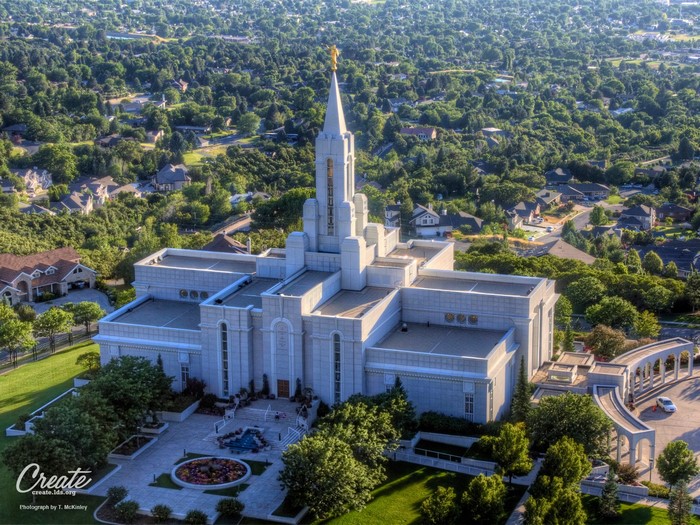 Aerial view of a large white temple with a golden spire