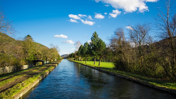 Canal waterway with trees and blue sky