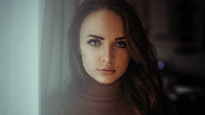 Woman with long brown hair wearing a turtleneck
