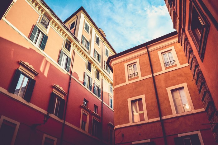 Buildings with windows and shutters under a blue sky