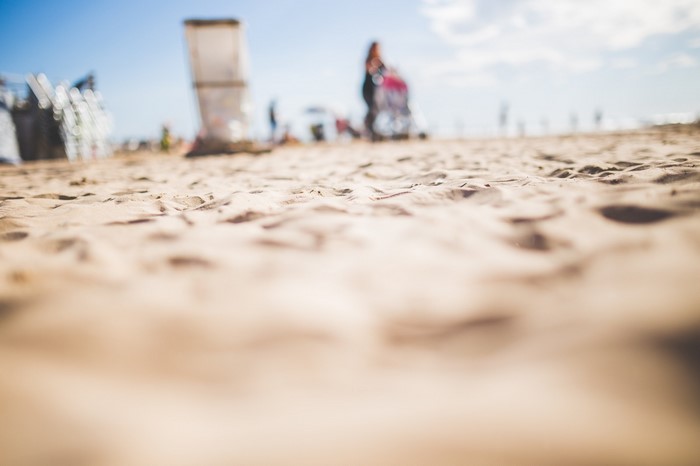 Beach with sand in the foreground and people in the background