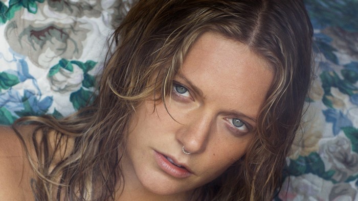 Tove Lo close up portrait with floral background
