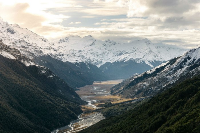 Snow-capped mountains and a winding river valley