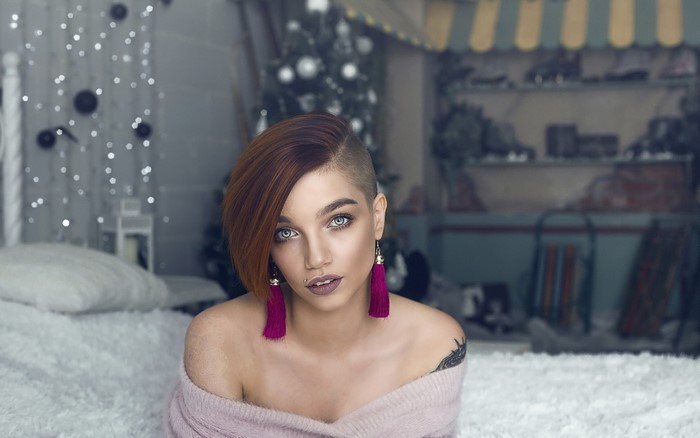 Woman with undercut hairstyle and pink sweater
