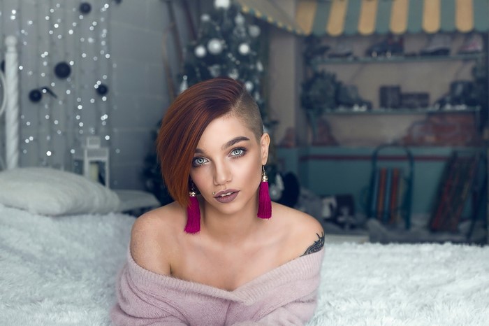 Woman with undercut hairstyle and pink sweater