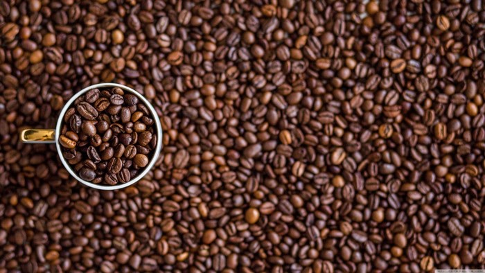 Coffee beans in a cup and background