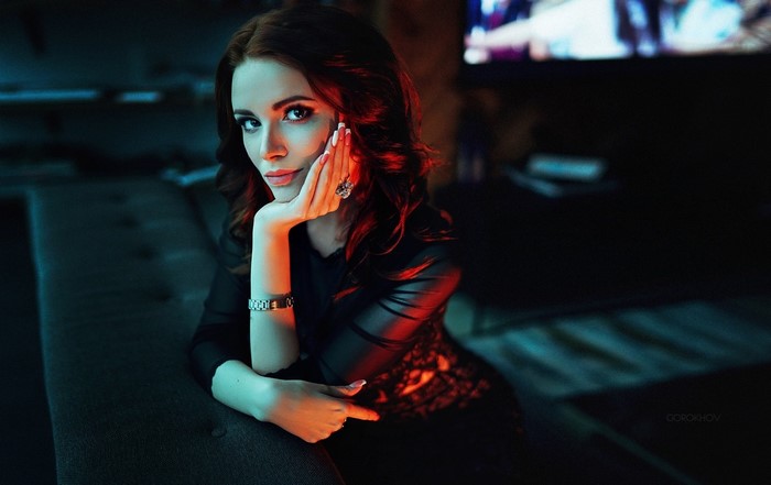 Woman with auburn hair in a black dress