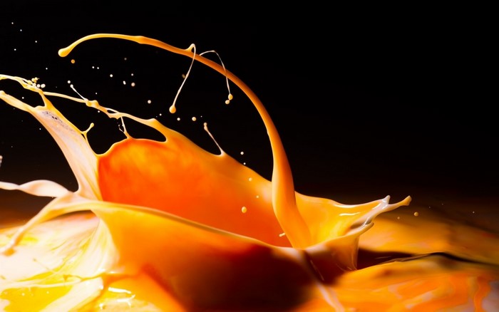 Orange liquid splash against black background
