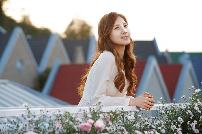 Asian woman in white dress with flowers and houses