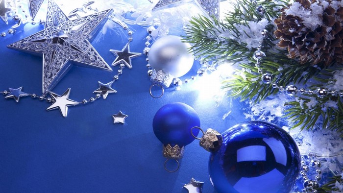 Christmas ornaments and pine branch on blue background