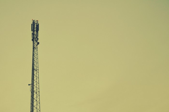 Cell tower against a pale sky