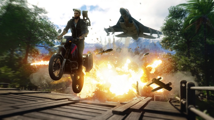 Rico Rodriguez from Just Cause 4 on a motorcycle during an explosion