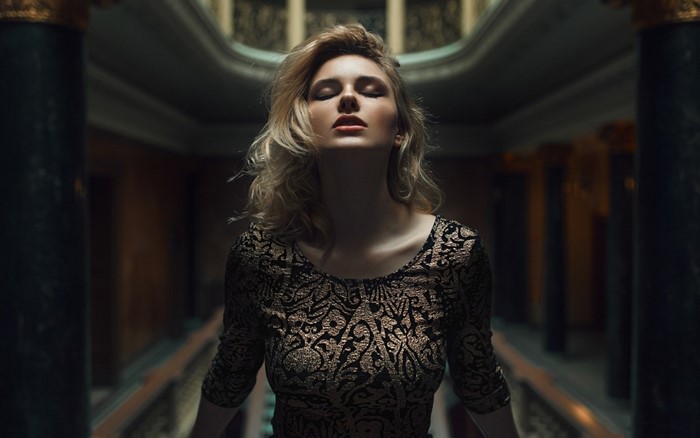 Woman with closed eyes in a patterned dress