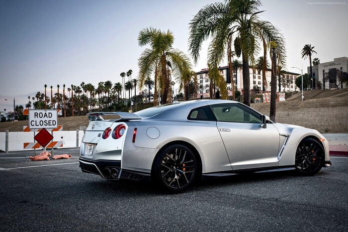 Silver Nissan GT-R Premium parked near road closure