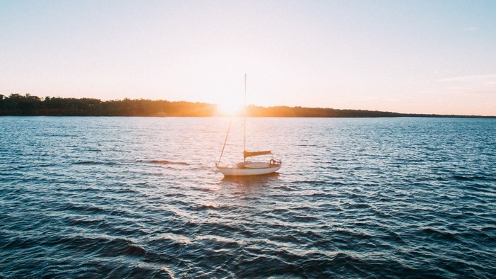 Sailboat on the water at sunset