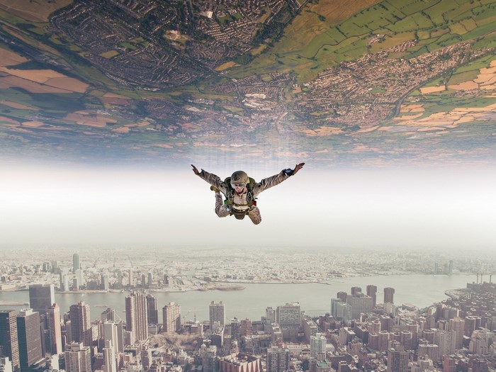 Skydiver over New York City and rural landscape