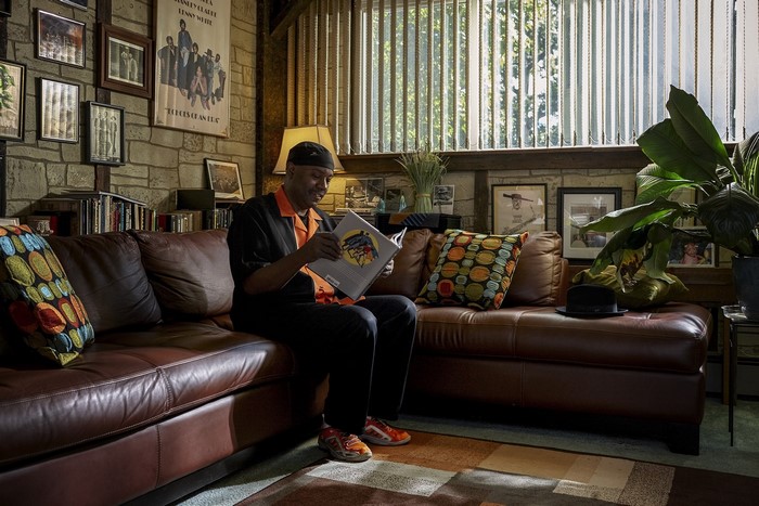 Man reading a book in a living room