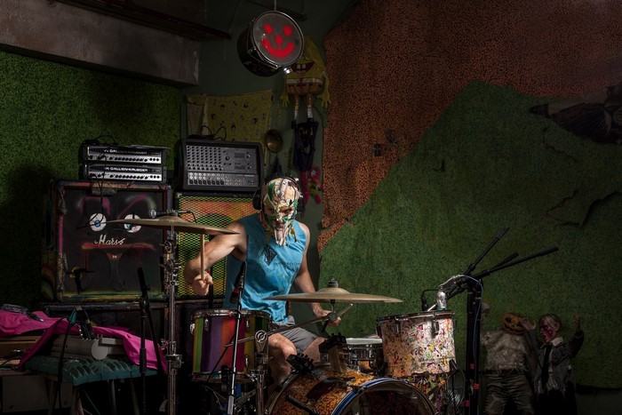 Musician playing drums in a decorated room