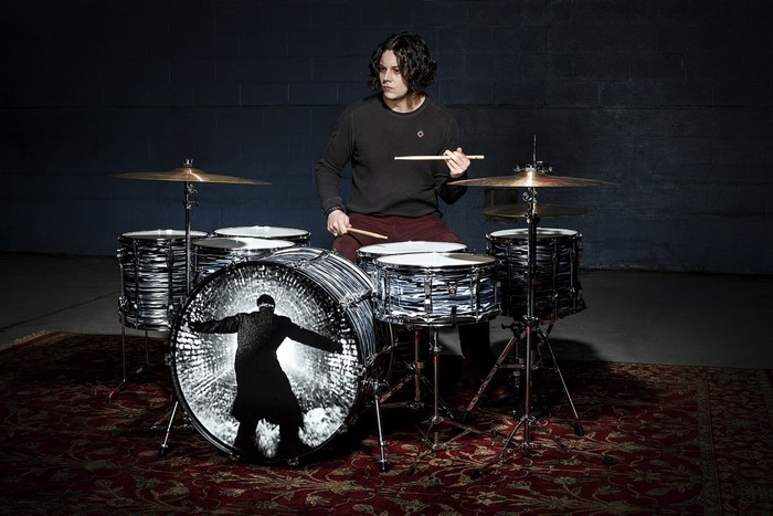 Jack White playing drums with custom bass drum art