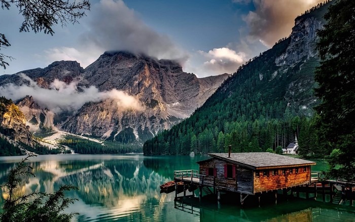 Lake Braies with wooden cabin and mountains, Italy