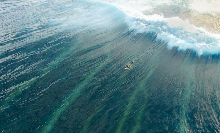 Surfer riding a large wave in the ocean