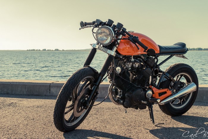 Orange Yamaha XV500 Cafe Racer Motorcycle by Water