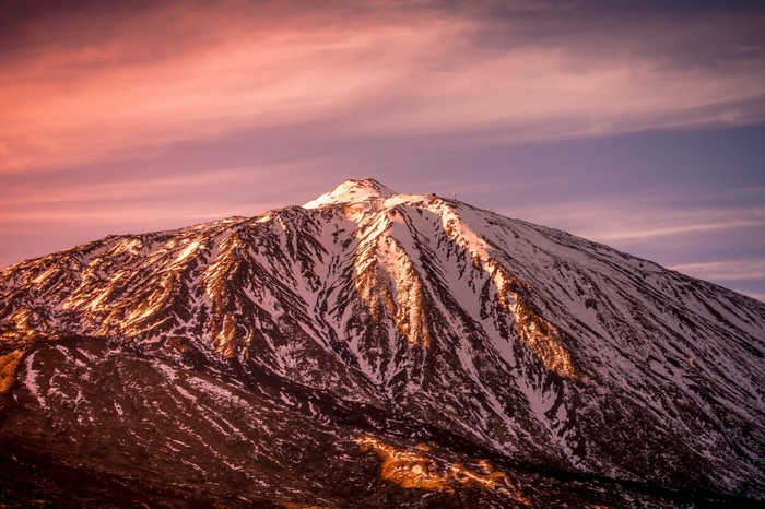 Snow-capped mountain peak at sunset