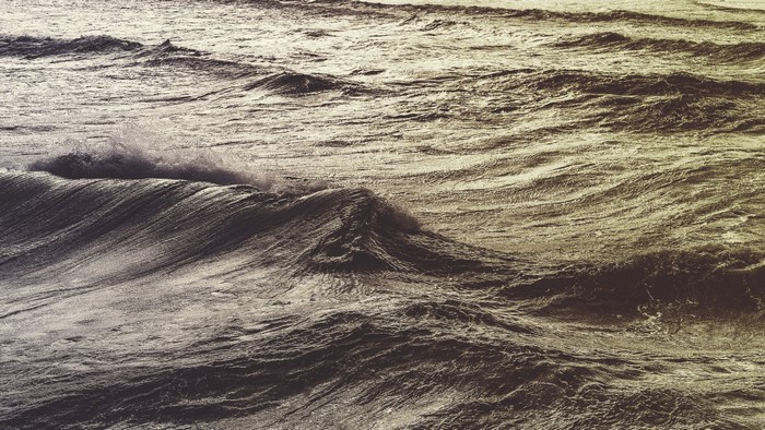 Monochrome image of ocean waves crashing