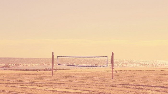 Beach volleyball net at sunrise or sunset