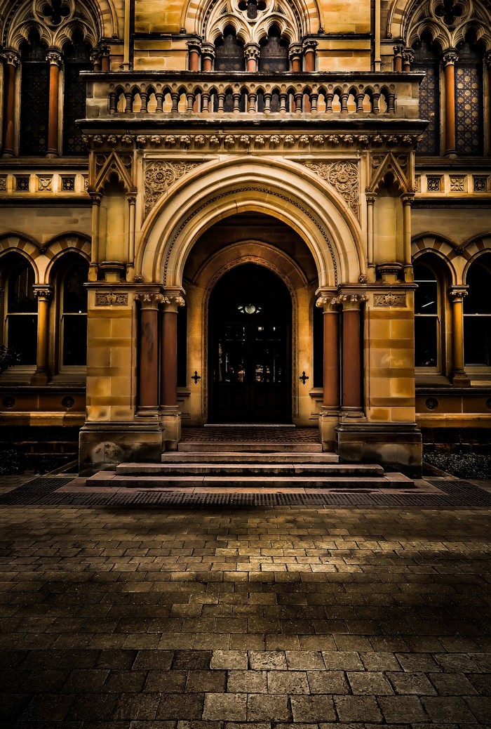 Gothic Archway Entrance to a Historic Building at Night