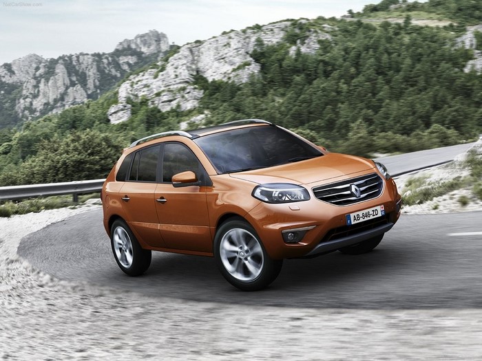 Orange Renault Koleos driving on a mountain road