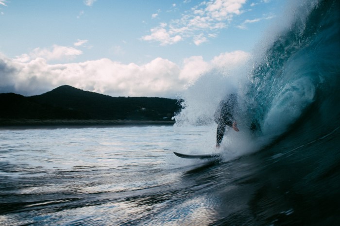 Surfer riding a wave in the ocean