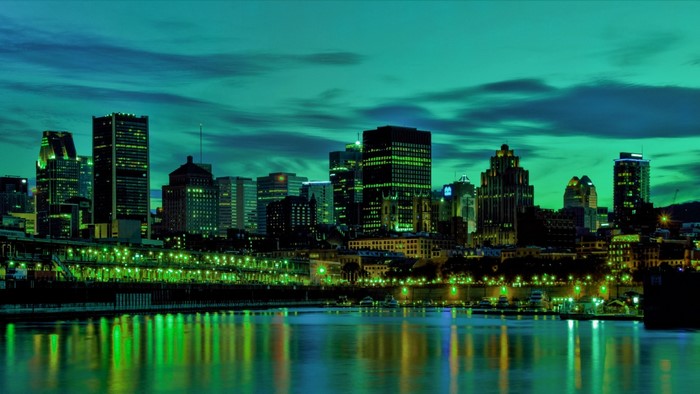 Montreal cityscape at night with river reflection
