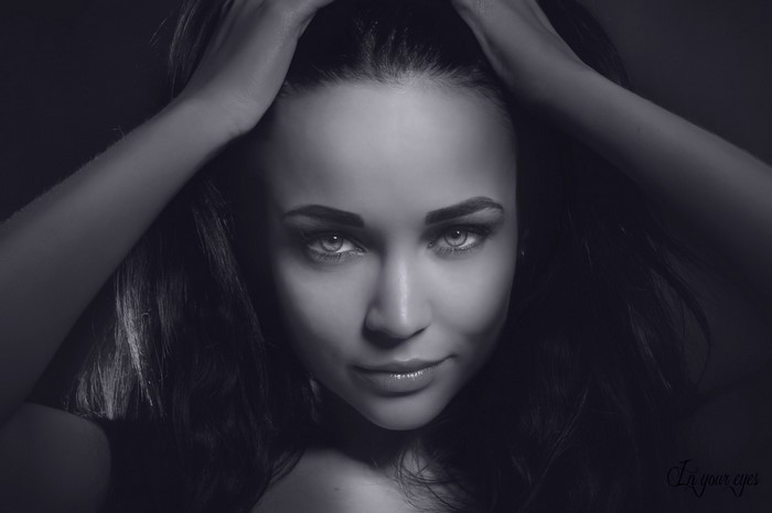 Monochrome portrait of Angelina Petrova with hands on head