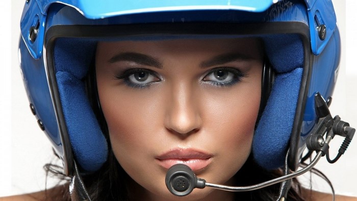 Woman wearing a blue racing helmet with a microphone
