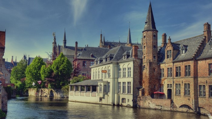 Bruges, Belgium canal with historic architecture and trees