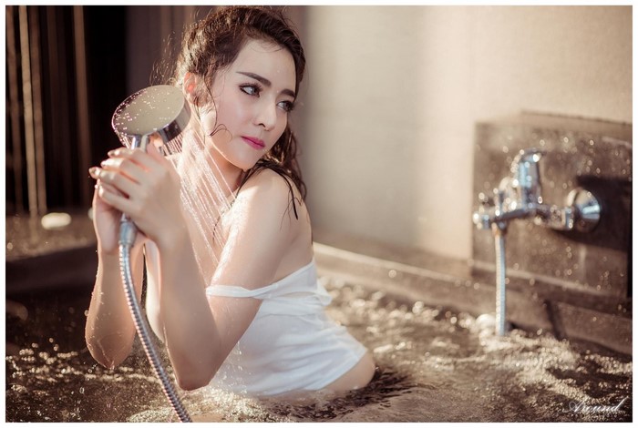 Asian Woman in White Dress with Shower Head