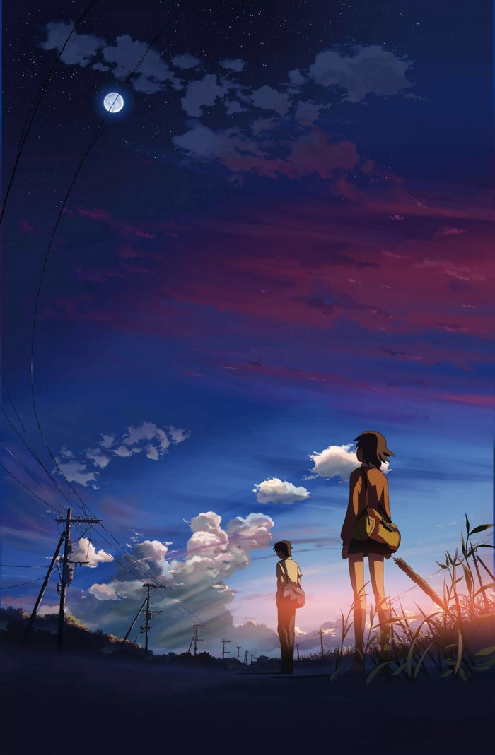 Two people looking at the sky at sunset
