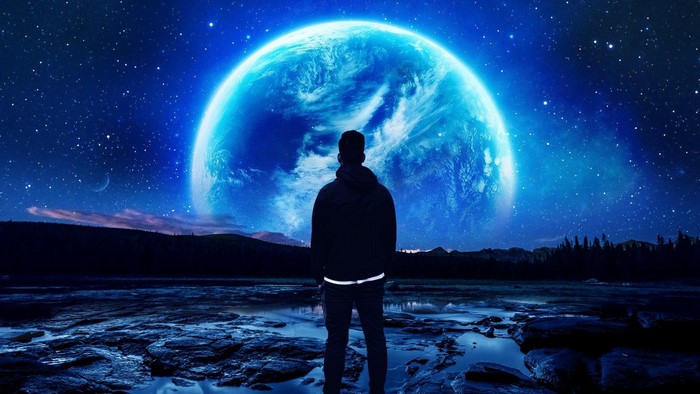Person looking at a large blue planet in space