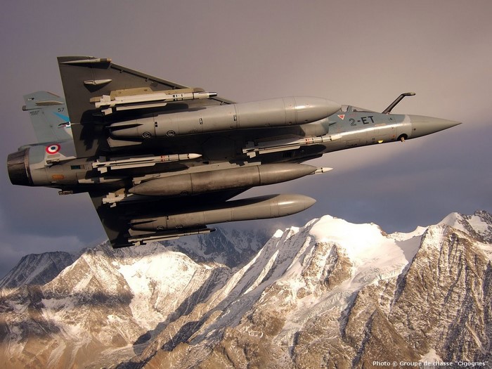 French Air Force Mirage 2000 fighter jet flying over mountains