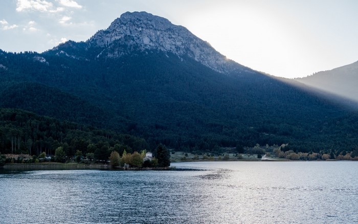 Lake and Mountain Forest Landscape with Sun Rays
